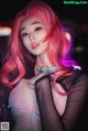 A woman with pink hair wearing a pink wig.